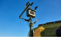 N-Channel beamforming system mounted on a military vehicle against a clear blue sky